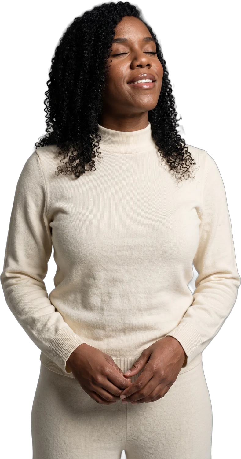 A woman breathing out, eyes closed, at ease